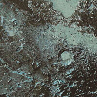 Frozen, cratered landscape on Pluto showing rough icy terrain