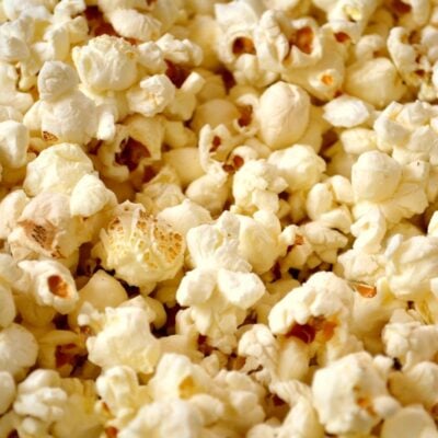 Close-up view of freshly popped popcorn with a mix of fluffy white and light yellow kernels.