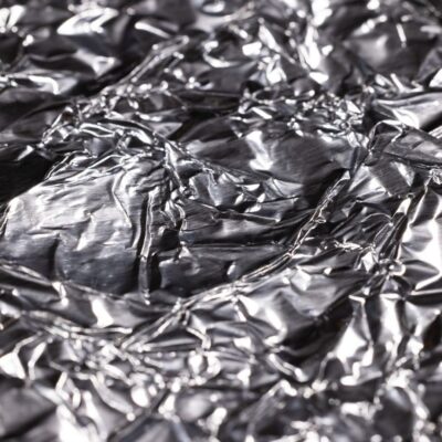 Close-up of crumpled aluminum foil with reflective surface