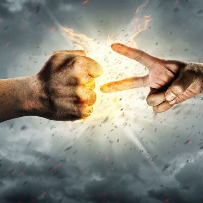 Two hands playing rock, paper, scissors with dramatic fire and smoke effects