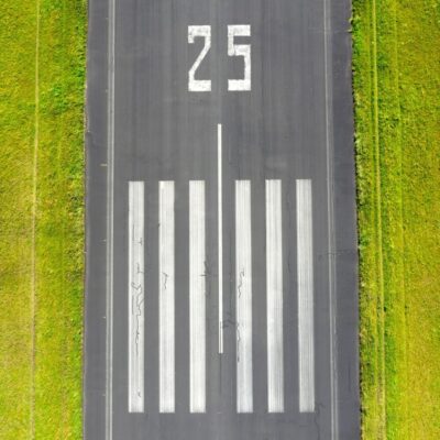 Runway marked with the number 25 and white threshold stripes