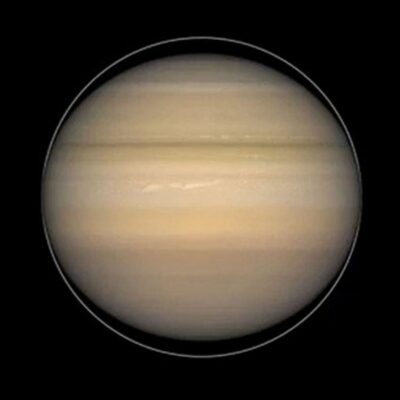 Saturn appearing flattened at the equator with visible cloud bands