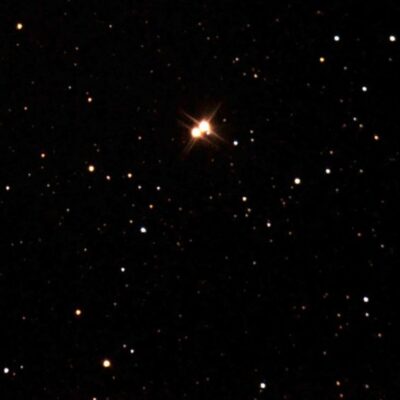 Bright binary star 61 Cygni surrounded by smaller stars in space