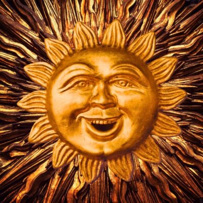 Golden sun with a smiling face and detailed rays