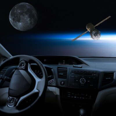 Car interior view with the Moon and a satellite visible in space ahead