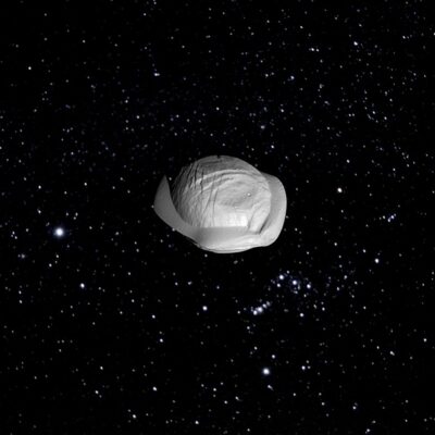 Saturn’s moon Pan with a distinct ridge, floating in space