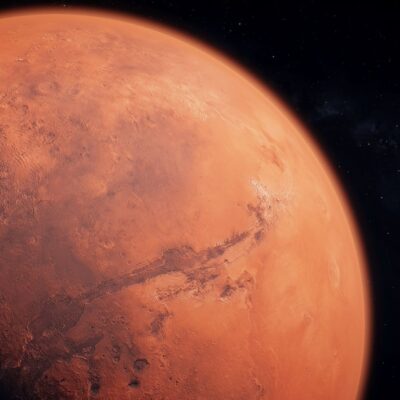 Surface of Mars showing craters and canyon under space backdrop