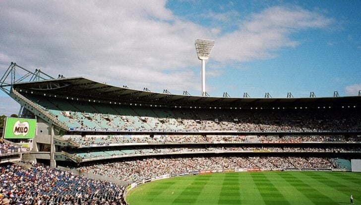Stadium filled with spectators watching a cricket match