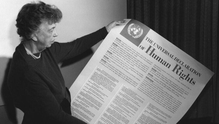 Eleanor Rooseveldt holding a large copy of the Universal Declaration of Human Rights document