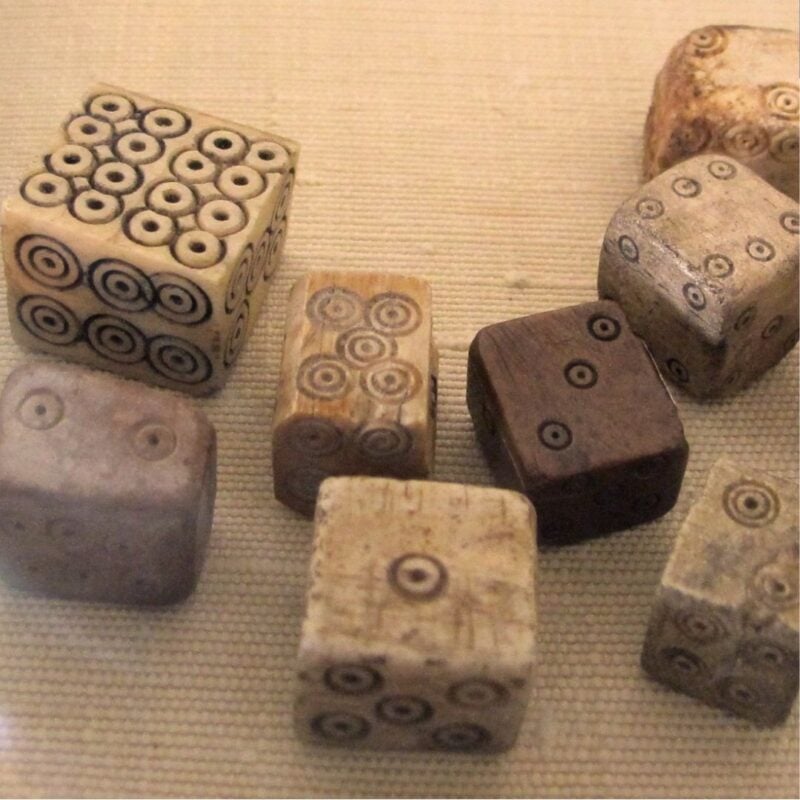 Ancient carved bone dice with circular markings on each face
