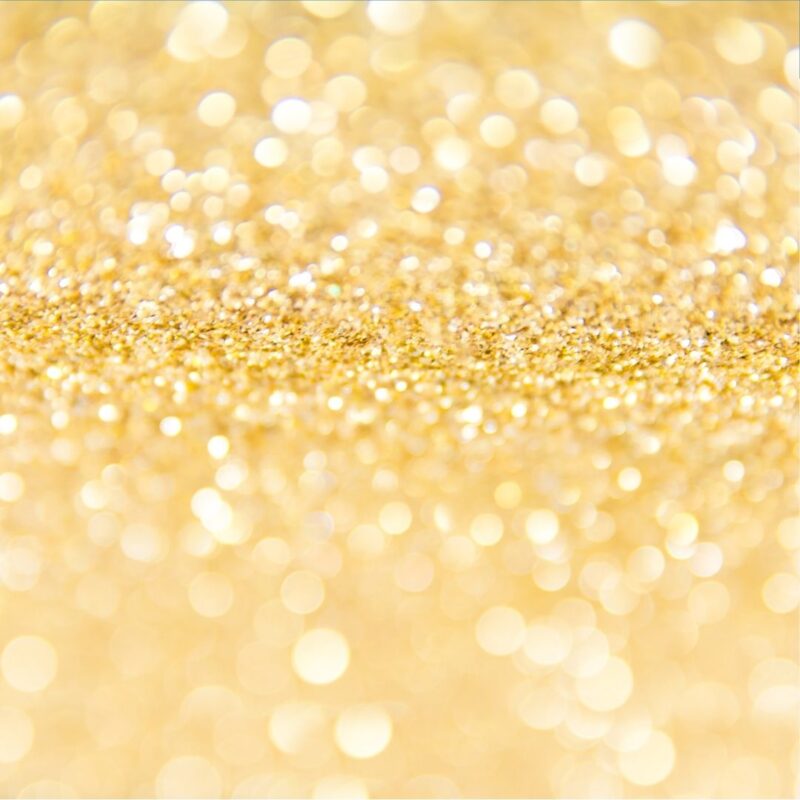 Close-up of sparkling gold glitter with a blurred bokeh effect