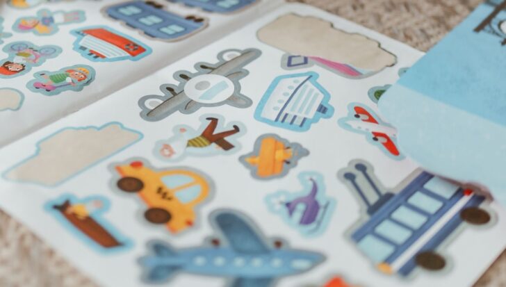 A collection of colorful stickers featuring various transportation modes like cars, airplanes, and ships along with playful characters