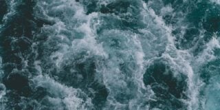Churning ocean waves with white foam on the water's surface