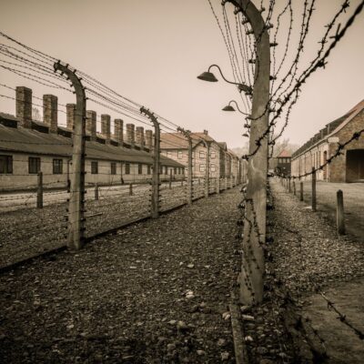 Barbed wire fences and brick buildings at a Nazi concentration camp