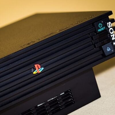 Close-up of a black PlayStation 2 console with power and reset buttons