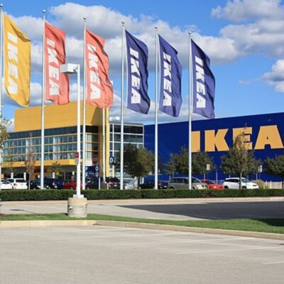 IKEA store with tall flagpoles and colorful banners in front
