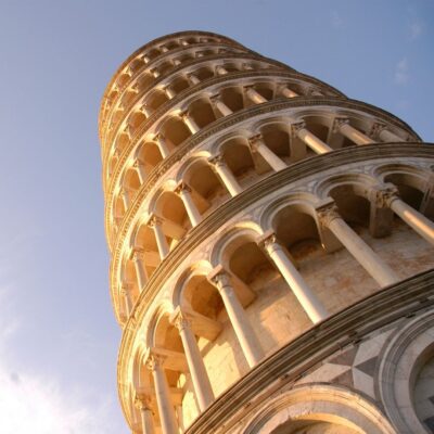Leaning Tower of Pisa bathed in warm light against a blue sky