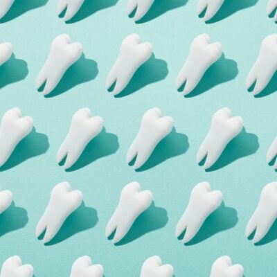 Pattern of white molar teeth icons on a teal background