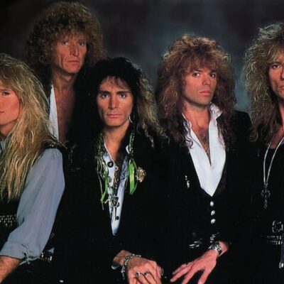 Whitesnake band members with long hair wearing dark jackets