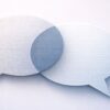 Two overlapping speech bubbles with text and binary code