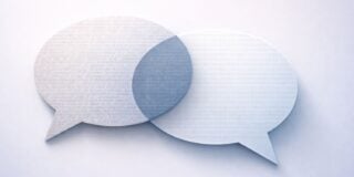 Two overlapping speech bubbles with text and binary code