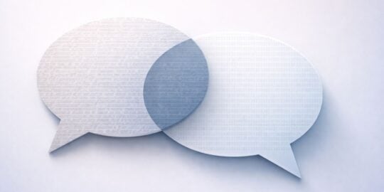 Two overlapping speech bubbles with text and binary code