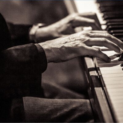 Close-up of hands playing the piano