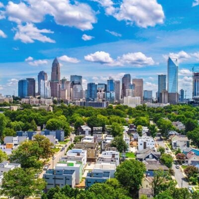 Downtown skyline with high-rise buildings over a green residential area
