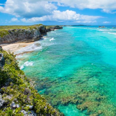 Turquoise sea along a rocky coastline with a sandy cove