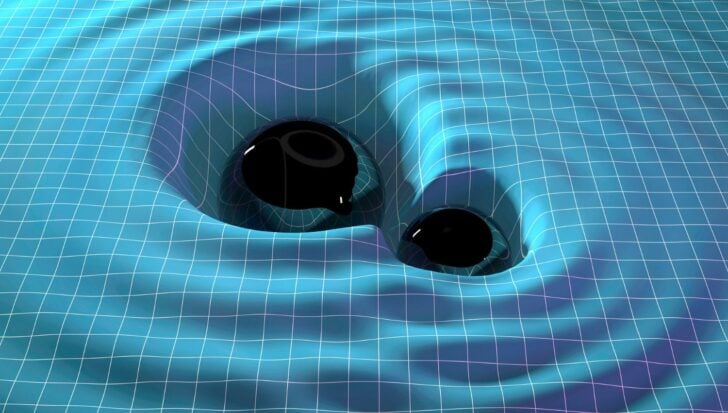 Two merging black holes illustrated on a grid-like fabric representing spacetime