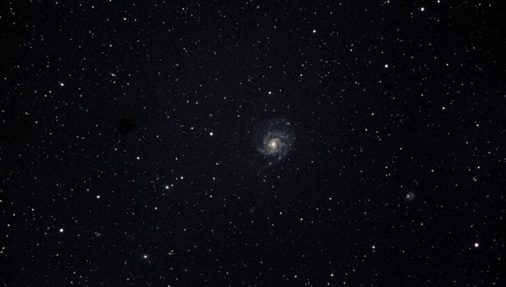 A star-filled sky with a spiral galaxy