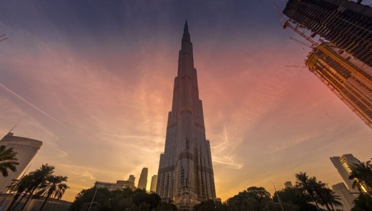 The Burj Khalifa at sunset, with a clear sky and surrounding skyscrapers