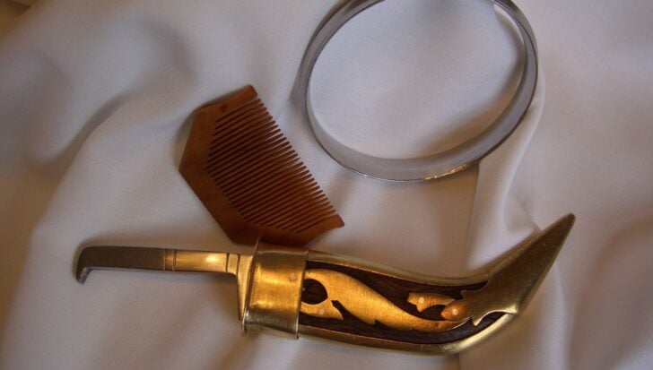 A wooden comb, a steel bangle, and a ceremonial sword