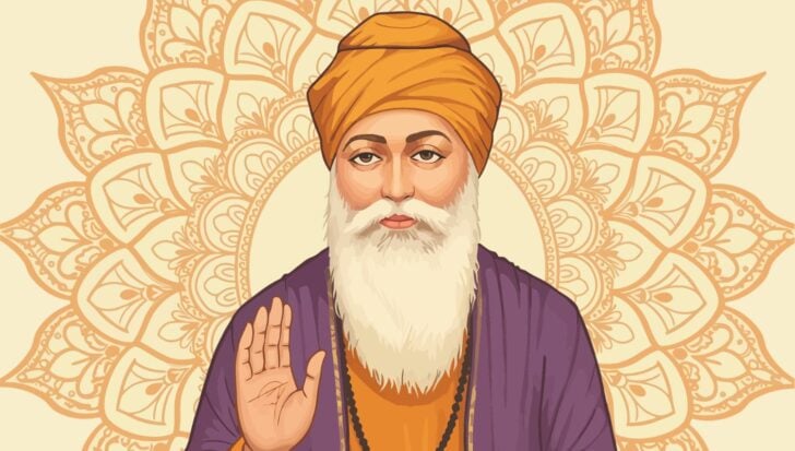 Sikh man with an orange turban and white beard
