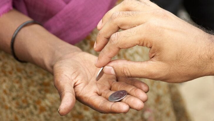 Two hands exchanging coins
